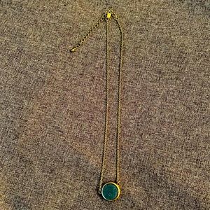 Gold necklace with sparkly blue stone